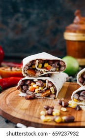 Nice Vegetarian Burrito Over Black Table On Wooden Board