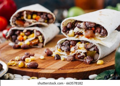 Nice Vegetarian Burrito Over Black Table On Wooden Board