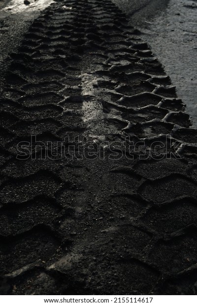 nice wallpaper, is an object of truck tire tracks on\
a layer of black soil