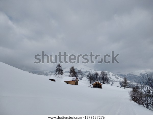 Nice\
winter landscape. Cabin in the Carpathian mountains covered with\
snow in Romania, Trasilvania, village of\
Parva.
