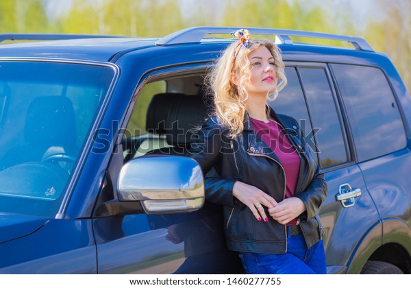 Nice woman car driver, outdoor portrait, automobile\
and lady