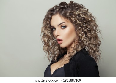 Nice woman with curly hairstyle on white background