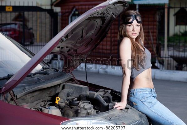 Nice woman mechanic\
repair broken red car