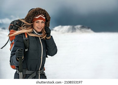Nice Woman Tourist Hiking in Snowy Mountains. Active People on Winter Holidays. Backpacker Travels to Iceland. Extreme Outdoor Activities. - Powered by Shutterstock
