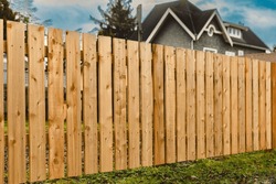 Nice Wooden Fence Around House. Wooden Fence With Green Lawn. Street Photo, Nobody, Selective Focus