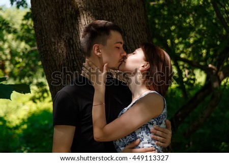 Nice young couple kissing in summer park