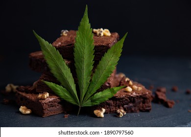 Nicely Displayed Cannabis Infused Pot Brownies With A Marijuana Leaf On A Black Background. 