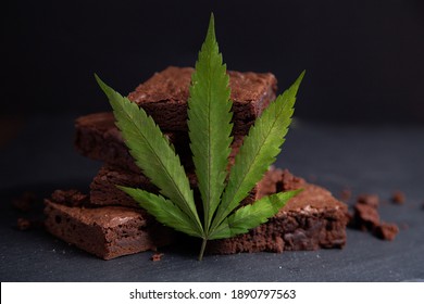 Nicely Displayed Cannabis Infused Pot Brownies With A Marijuana Leaf On A Black Background. 