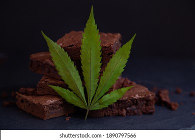 Nicely Displayed Cannabis Infused Pot Brownies With A Marijuana Leaf On A Black Background. 