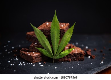 Nicely Displayed Cannabis Infused Pot Brownies With A Marijuana Leaf On A Black Background. 