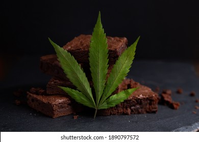 Nicely Displayed Cannabis Infused Pot Brownies With A Marijuana Leaf On A Black Background. 