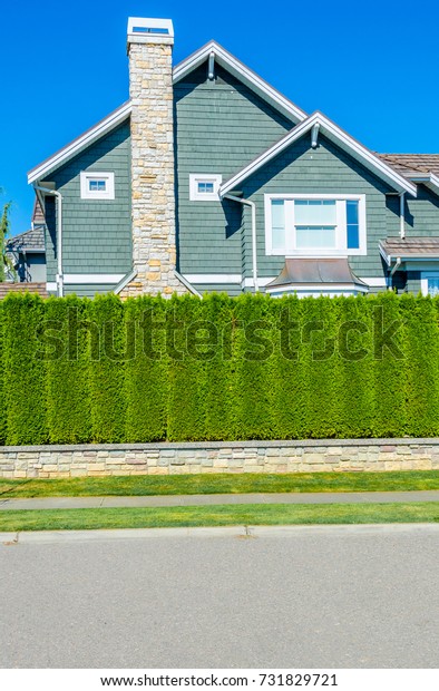Nicely trimmed bushes and flowers in front of the
house. Separate and protect private property. Keeps privacy and
security. Landscape
design.