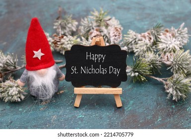 Nicholas imp with the text Happy St, Nicholas Day on a chalkboard. - Shutterstock ID 2214705779