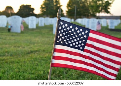 Nicholasville, Kentucky, U.S.A.  Camp Nelson National Cemetery. October 17, 2016.  Small American Flag Waving In Foreground With White Marble Tombstones In The Background.  Editorial Use Only.