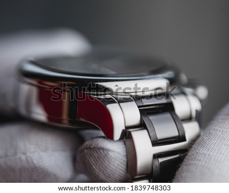 The nick on the watch case is a dent in the polished chrome