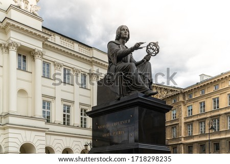 Nicolaus Copernicus Monument in Warsaw, Poland, bronze statue of a Polish astronomer from 1830, on background of old buildings