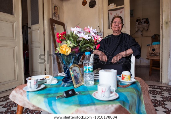 Nicosia / Northern\
Cyprus - August 15, 2019: nice old turkish woman drying her\
fingernails and having hair dyed in house in the part of Nicosia\
belonging to North\
Cyprus