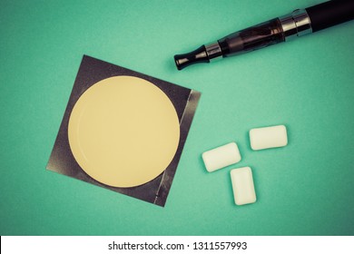 Nicotine Patch, Chewin Gum And Ecigarette Used For Smoking Cessation Isolated On Green Background