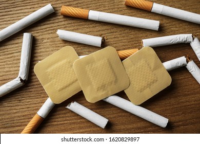 Nicotine Patches And Cigarettes On Wooden Table, Flat Lay