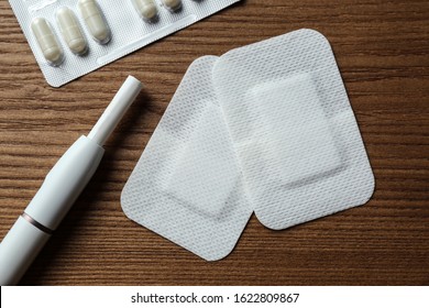 Nicotine Patches, Pills And Electronic Cigarette On Wooden Table, Flat Lay