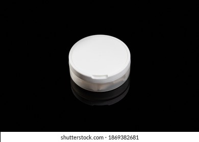 Nicotine Pouch Container Isolated On A Black Background With Reflection. Outer Space. Studio Shot. Snus Tobacco Product.