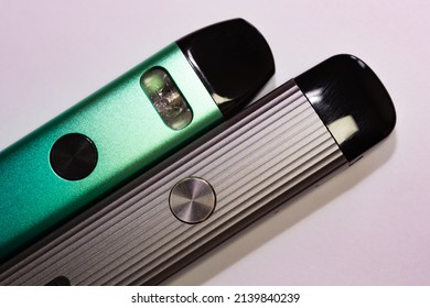 Nicotine Vapor Sticks Top View. Green And Gray Electronic Cigarettes On Isolated White Background.