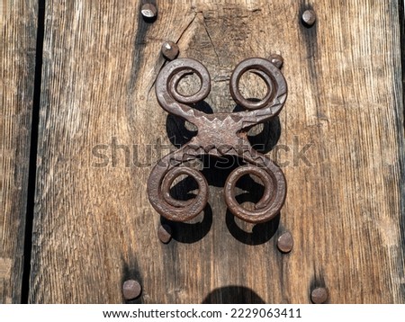 Nicula, Romania - July 20 2022:  Old iron  door handle at Nicula monastery. Nicula Monastery is an important pilgrimage center in North Transylvania. 