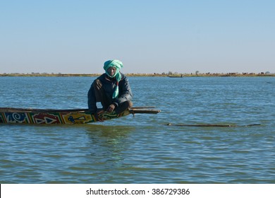 NIGER RIVER, MALI, JAN 05: A Fisherman Sits On The Back Of His Traditional Boat Named 