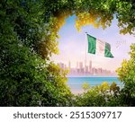 Nigeria flag waving with modern skyline. A flag blow behind the tree leafs. Nigeria national flag for independence day.