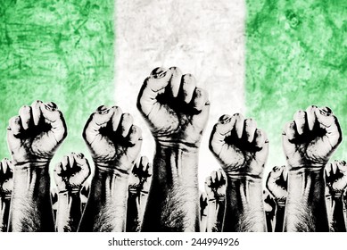 Nigeria Labor movement graphic concept, workers union strike concept with male fists raised in the air fighting for their rights and Nigerian national flag in out of focus background. - Shutterstock ID 244994926