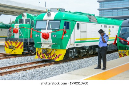 A Nigerian Police Officer Stands In Front Of The Newly Acquired Trains In Lagos, Nigeria On The June 9th, 2021