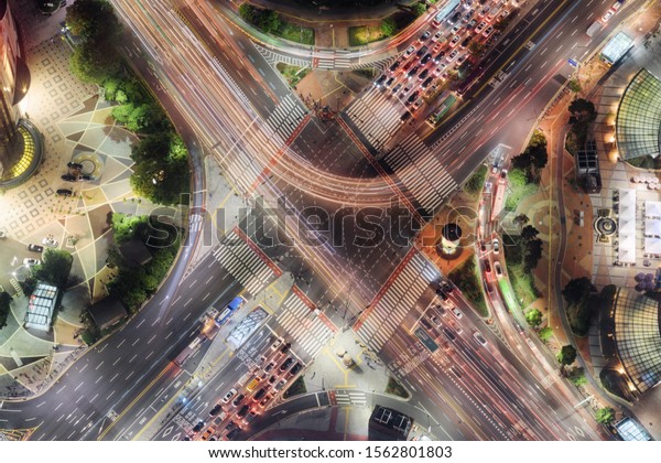 Night aerial view of road intersection at downtown\
of Seoul in South Korea. Cars and colorful buses on streets in\
evening. Night city traffic. Seoul is a popular tourist destination\
of Asia.