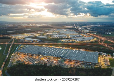 Night aerial view of a warehouse of goods for online stores. Logistic center in the industrial area of the city from above.