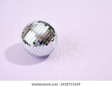 Night alcohol party. Shining mirror disco ball on a purple background. Copy space for text. - Powered by Shutterstock