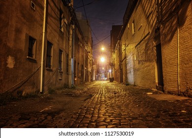 night back street, looks dangerous and deserted with nobody and mystery, bricks road. 