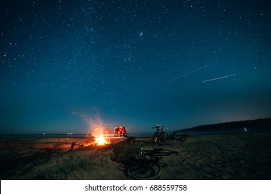 Night Beach Bonfire Under The Stars With Bikes In Foreground