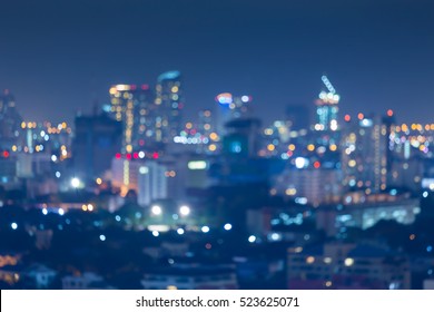 Night blurred bokeh light city office building, abstract background 