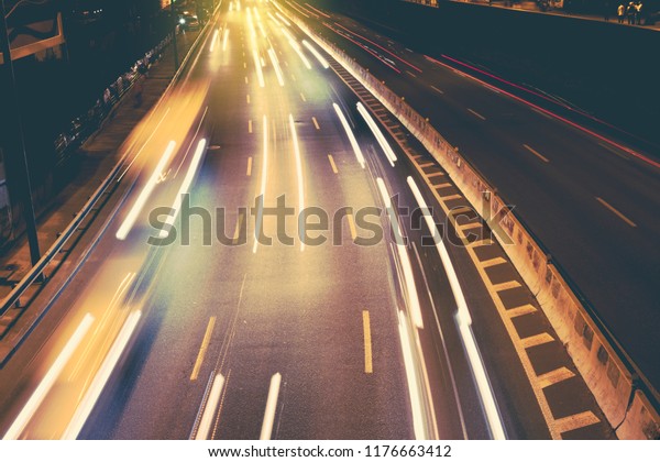 Night car city raffic. Motion blur car on the\
highway in big modern\
city.