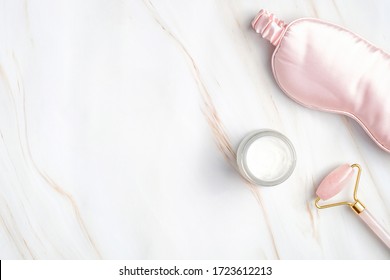 Night care cream for face, sleeping eye mask, facial massage roller on marble background. nighttime skincare routine concept. - Shutterstock ID 1723612213