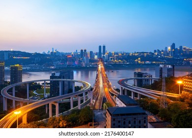 At night, the circular overpass and the urban skyline are in Chongqing, China - Shutterstock ID 2176400147