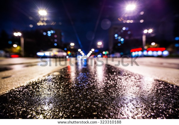 Night city after rain, the glowing lights of\
approaching cars. Wide angle view of the level of the pedestrian\
crossing, in blue tones