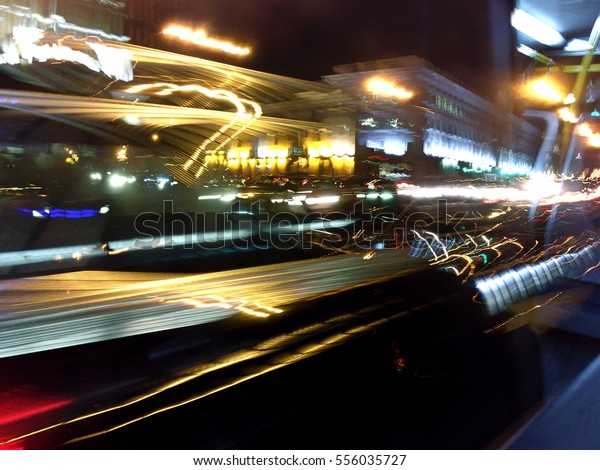 night city asphalt road background with\
marking lines and colorful\
reflections