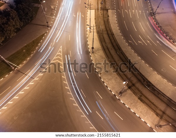 Night city center crossroad traffic\
lights in long exposure. Aerial look down view on cars driving with\
illumination. Downtown streets in Kharkiv,\
Ukraine