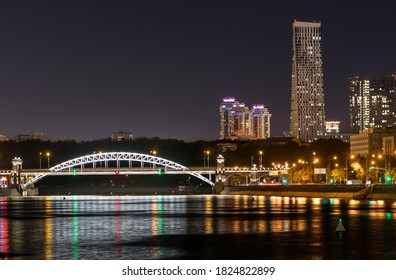 Night City With Skyscrapers And A Bridge Over The River With Lights Reflected In The Water. Megapolis Moscow