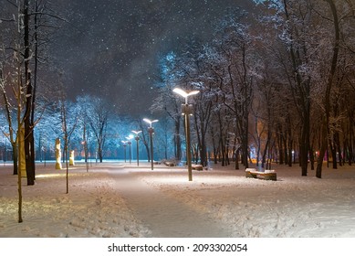 night city square with lantern covered by snow, night city winter scene - Powered by Shutterstock