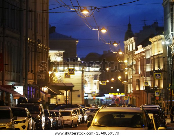 Night city. Street, illumination and\
lights, parked cars. Saint Petersburg,\
Russia