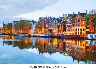 Night city view of Amsterdam, the Netherlands with Amstel river