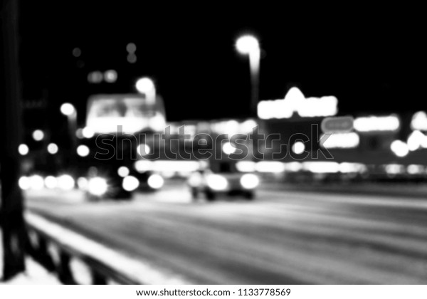 Night city view in blur. City Speed Traffic lights\
blurry. Street life bokeh image. Street with traffic and cars\
defocused image. Road in big city bokeh image. Blurred Night city.\
Black and white