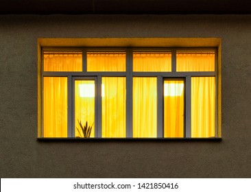 Night In City With Yellow Light Inside Big House Window