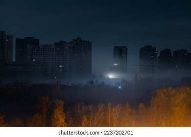 Night cityscape. City street at night with high modern buildings among the fog with illumination from a street light. Blackout in Kyiv. Ukraine. - Shutterstock ID 2237202701